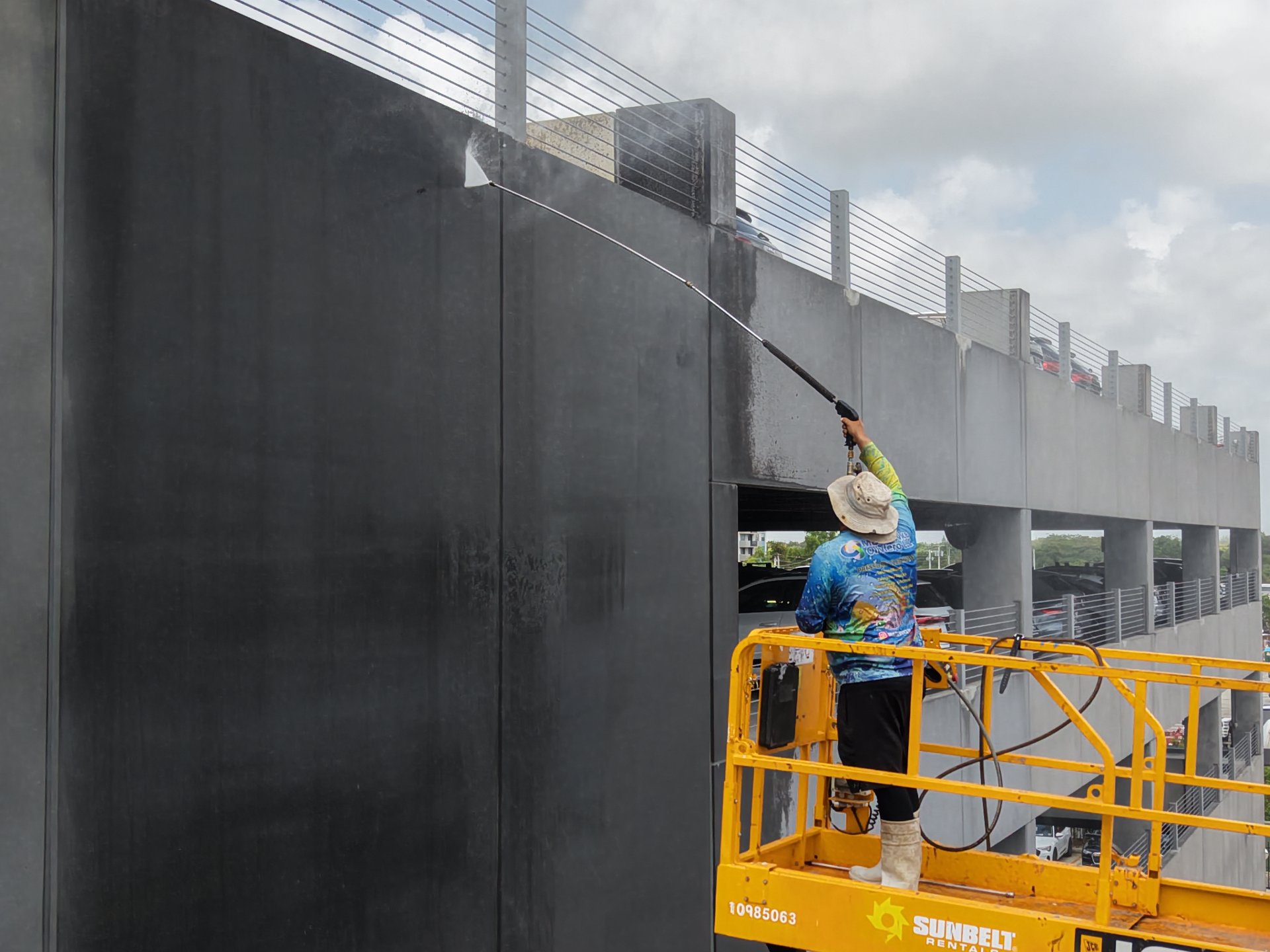 Removing grime from parking structure walls with pressure washer in Hialeah FL